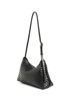 Side profile of the 81 Baguette Bag, highlighting its slim silhouette and artisanal craftsmanship.