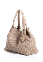 Side profile of the 09 Regular Acacia bag, highlighting its structured silhouette and warm grey tone