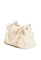 Side profile of the 09 Small Butter  bag, highlighting its structured silhouette and warm beige tone